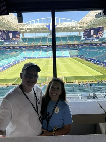 Kenney Assigning leadership watching a match from a stadium suite